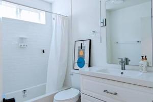 a white bathroom with a sink and a toilet at Designer 1BR 1BA Culver City Sony Studios in Los Angeles