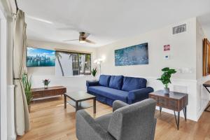 a living room with a blue couch and chairs at Beach Condo 2BR & Efficiency Combo on Hollywood Beach in Hollywood +34 photos