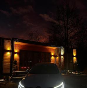 a car parked in front of a house at night at Stablo guest house in Bărăşti