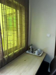 a table with a tea set on top of it at Private Room In Cotonou Home in Cotonou