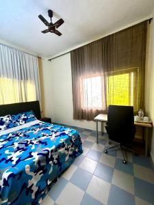 a bedroom with a bed and a ceiling fan at Private Room In Cotonou Home in Cotonou
