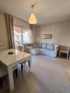 a living room with a couch and a table at Relax al Mare in Vallecrosia