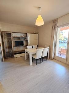 a kitchen and dining room with a table and chairs at Relax al Mare in Vallecrosia +6 photos