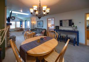 a dining room and living room with a table and chairs at Birchwood Lodge in Sister Bay