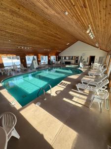 a large swimming pool with chairs and a table at Birchwood Lodge in Sister Bay