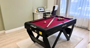 a pool table with a ball and bats on it at Modern and Spacious 3 Bed House, Sleeps 5, Close to Southampton City Centre, in Southampton