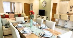 a dining room and living room with a table and chairs at Modern and Spacious 3 Bed House, Sleeps 5, Close to Southampton City Centre, in Southampton