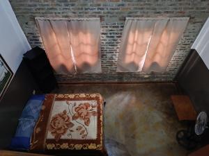 een kamer met 2 ramen en een bed met een tapijt bij Hotel Village del Sol in Puerto Iguazú
