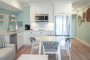 a kitchen with a table and a refrigerator at Manasota Key Resort in Englewood
