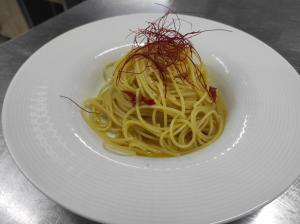 a white plate of pasta on a table at Hotel La Fattoria Sul Mare in Capo Vaticano