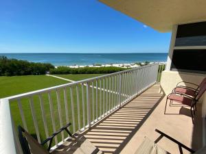 a balcony with chairs and a view of the ocean at EBT 302b in Fort Myers Beach