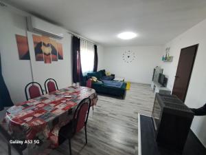 a living room with a table and a couch at Apartman T&N 