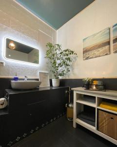 a bathroom with a sink and a counter with a sink at FeWo Jack's World in Luckenwalde