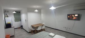 a room with a table and a kitchen with a refrigerator at Home Alojamientos Temporales in San Luis