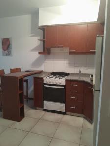 a kitchen with a stove and a counter top at Excelente departamento en Villa Luro in Buenos Aires