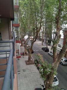 a view from a balcony of a street with trees at Excelente departamento en Villa Luro in Buenos Aires