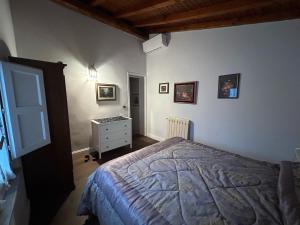 a bedroom with a bed and a dresser in it at Casa di Paco a Nicolosi in Mascalucia +14 photos