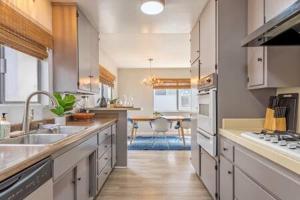 a kitchen with a sink and a stove top oven at Downtown Manhattan Beach 3 Bed Townhouse Parking in Manhattan Beach