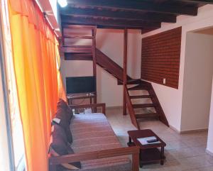 a living room with a bunk bed and a staircase at Departamentos Centricos Iguazu A.N in Puerto Iguazú