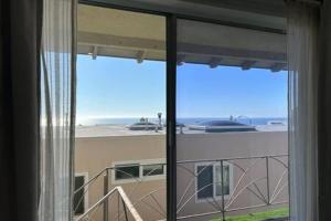 a room with a window with a view of a building at Ocean View Studio Manhattan Beach in Manhattan Beach