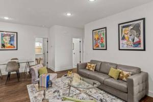 a living room with a couch and a table at The Warhol - Pet-Friendly Apartment in Bentonville