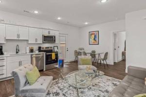 a kitchen and living room with a table and chairs at The Warhol - Pet-Friendly Apartment in Bentonville