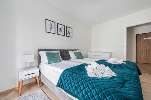 a bedroom with two beds with towels on them at Posejdon - BillBerry Apartments in Gdańsk