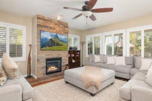a living room with a couch and a fireplace at Minutes to Wineries Outdoor Oasis Pool Table in Murrieta