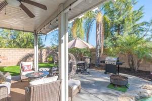 a patio with furniture and an umbrella and a grill at Minutes to Wineries Outdoor Oasis Pool Table in Murrieta