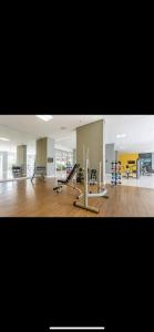 a gym with several treadmills and machines in a room at Apartamento premium - Df plaza in Brasilia +2 photos