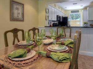 Una mesa de comedor con copas de vino encima. en 5067 Beachwalk, en Destin