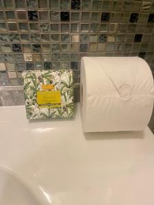 a roll of toilet paper and a bag on a counter at Albero Mago in Florence