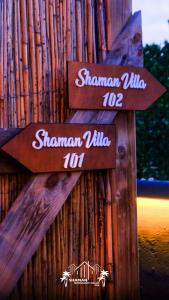 two signs that say shanghai village up and shaman village at Şile SHAMAN BUNGALOW VİLLAS 102 in Şile