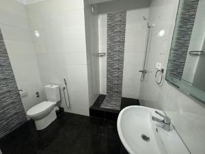 e bagno con servizi igienici, lavandino e doccia. di Crystal boulevard hôtel a Tangeri