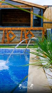 a water fountain in front of a swimming pool at Şile SHAMAN BUNGALOW VİLLAS 102 in Şile