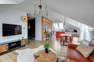 a living room with a couch and a table at Apartament Amber by Q4 Apartments Old Town in Gdańsk