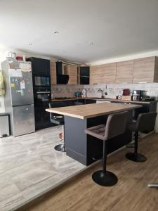 a kitchen with a large island in the middle of it at villa proche de coursseulles sur mer 