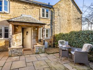 a patio in front of a house with a gazebo at 1 Bed in Blockley 53420 in Blockley