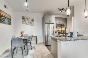 a kitchen and dining room with a table and chairs at Luxury 1Bedroom Apt with Pool in Austin