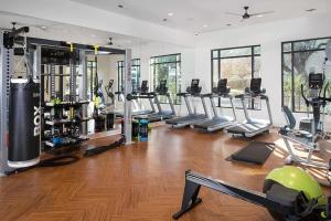 a gym with a bunch of treadmills and machines at Luxury 1Bedroom Apt with Pool in Austin