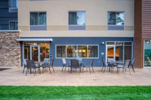 a patio with chairs and tables in front of a building at Fairfield Inn & Suites by Marriott Wisconsin Dells in Wisconsin Dells