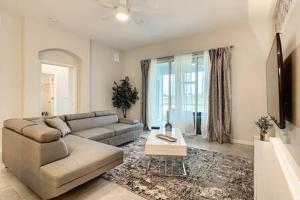 a living room with a couch and a table at Dazzling Thematic 2BR with Game Room in Davenport