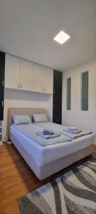 a bedroom with a large bed in a room at Mimoza in Novi Beograd