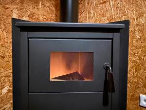 a black stove with a fire inside of it at Off-Grid Boat Experience - Stay Zero Footprint in Utrecht