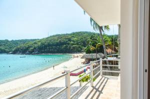 a view of the beach from the balcony of a house at La Playa departamento suites in Santa Cruz Huatulco