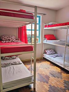 a room with three bunk beds and a window at Solar Hostel Beach Copacabana in Rio de Janeiro