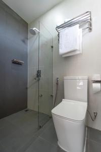a bathroom with a toilet and a glass shower at Silver Oasis Maldives in Huraa