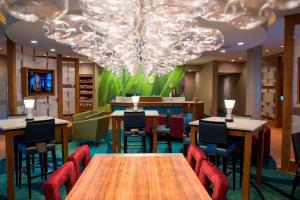 a restaurant with tables and chairs and a chandelier at SpringHill Suites by Marriott Wisconsin Dells in Wisconsin Dells