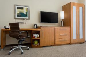 a living room with a tv and a chair at Hyatt Place Chicago/Downtown - The Loop in Chicago