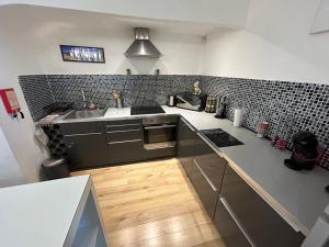 a kitchen with a sink and a counter top at Le cocon de Louise-Vieux Port in Marseille